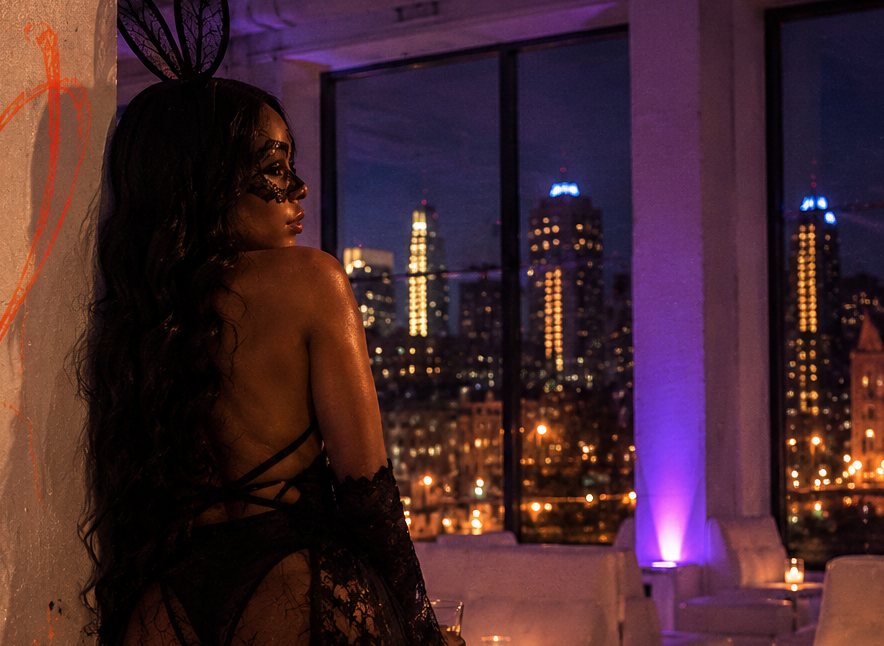 A masked guest at an Overlook costume night, Detroit skyline beyond